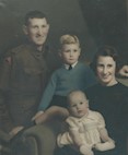 Wills Family Portrait, courtesy of Norman Charles Wills.  Father: Norman Louis WILLS - Note Army patch on right arm, Mother: Ethel Marie WILLS (nee HOGHTON), Older son: Norman Charles WILLS, Younger son: Noel Kevin WILLS