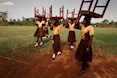 RANDY OLSON (2007) Schoolgirls in Ghana help prepare for the opening of the Maranatha Maternity Clinic by carrying chairs to the ceremony.  National Geographic exhibition "WOMEN.”